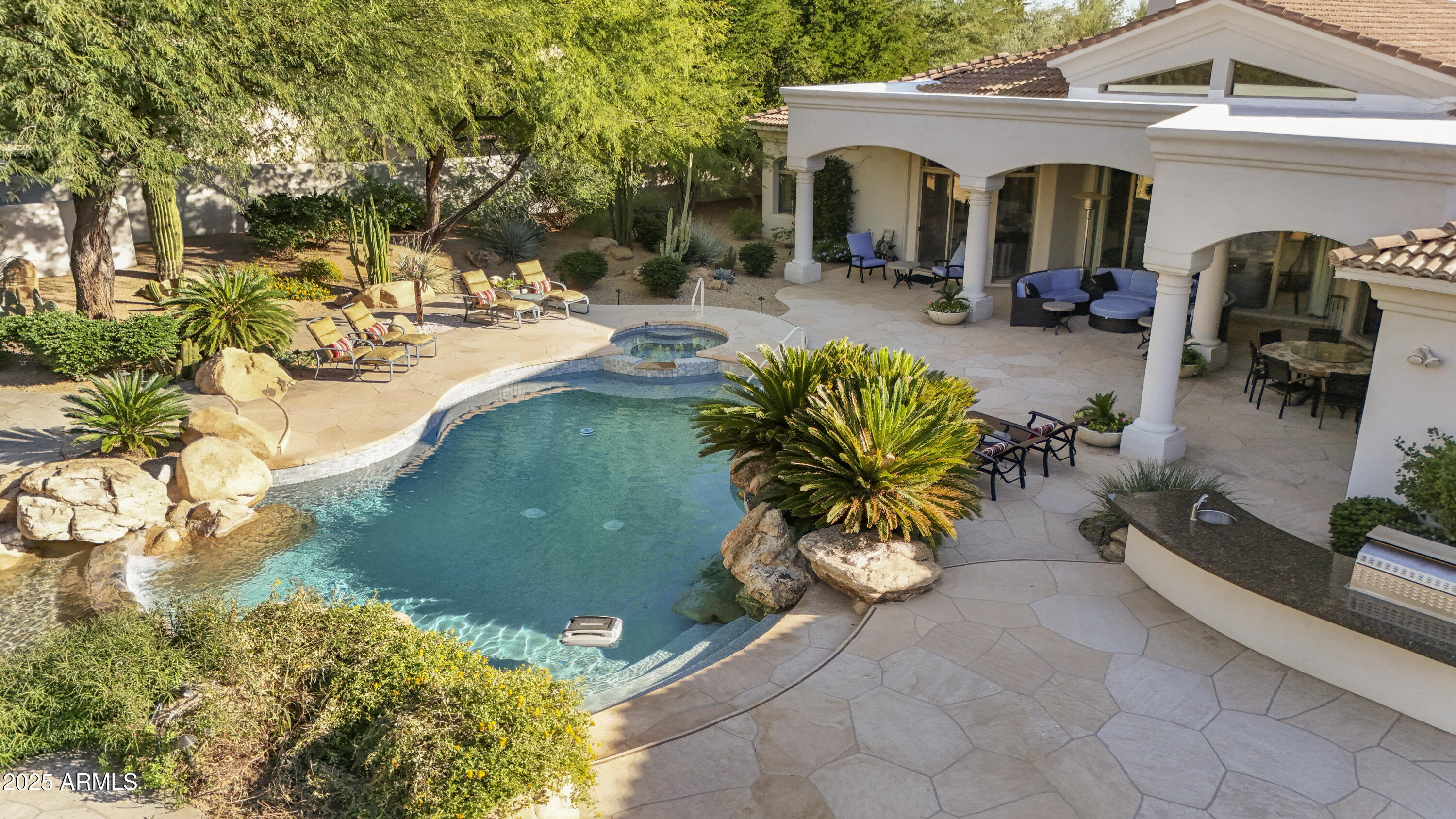 8350 East Via Del Sol Drive Scottsdale, AZ 85255 - Photo 38 of 42 a view of a backyard with couches under an umbrella