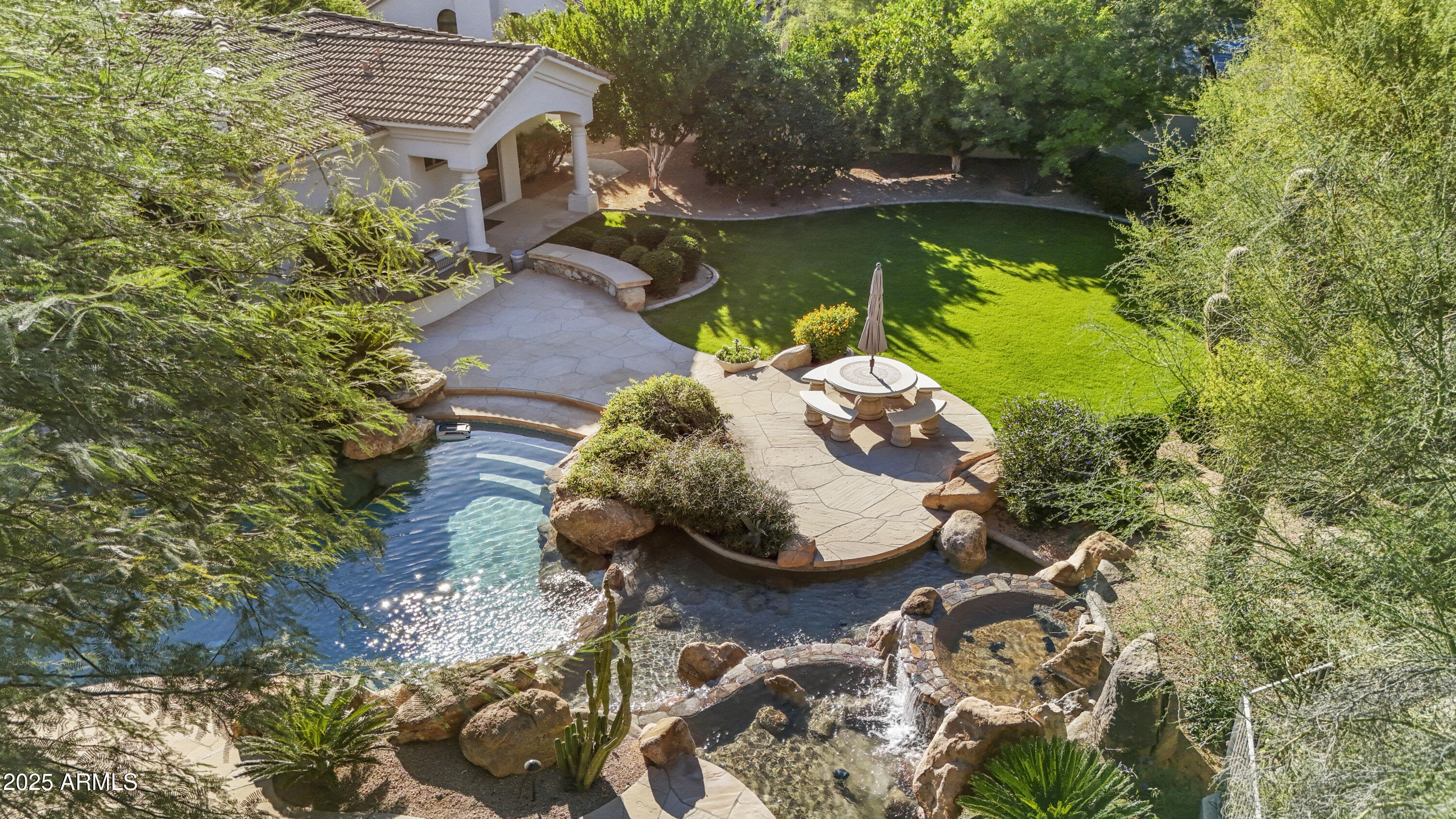 8350 East Via Del Sol Drive Scottsdale, AZ 85255 - Photo 39 of 42 an aerial view of a house with swimming pool and red chairs