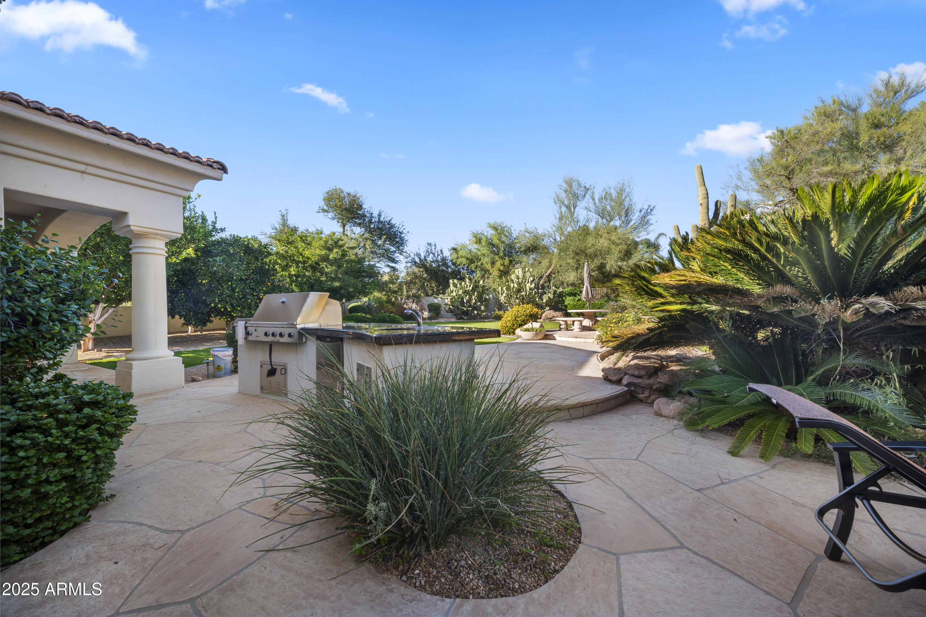 8350 East Via Del Sol Drive Scottsdale, AZ 85255 - Photo 40 of 42 a view of a yard with plants and a water fountain