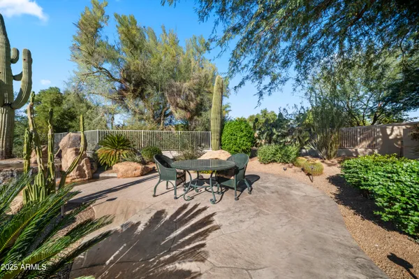 a backyard of a house with table and chairs