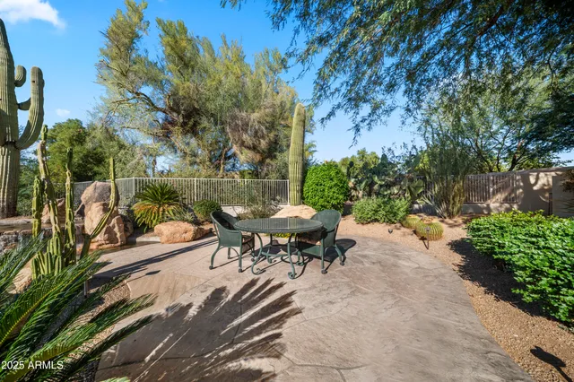 a backyard of a house with table and chairs