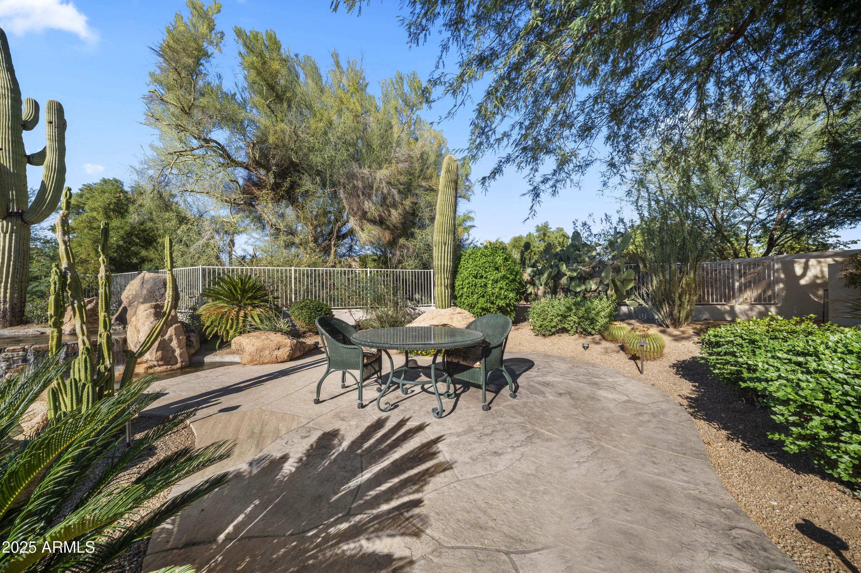 8350 East Via Del Sol Drive Scottsdale, AZ 85255 - Photo 41 of 42 a backyard of a house with table and chairs