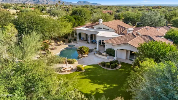 an aerial view of residential houses with yard