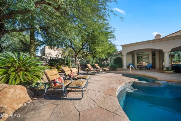 a view of a backyard with sitting area