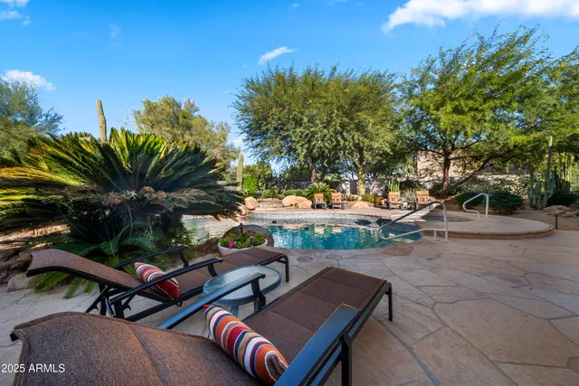 a view of a backyard with sitting area