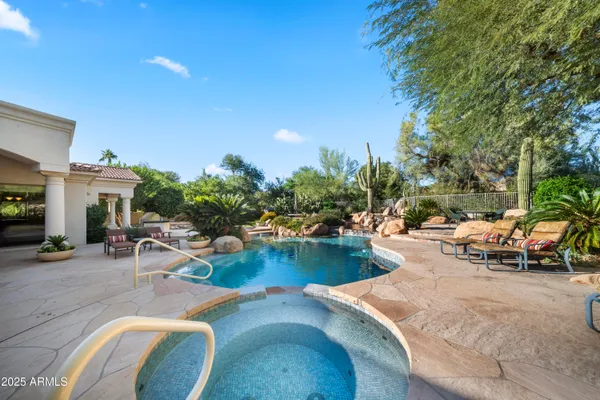 a view of swimming pool with outdoor seating and plants