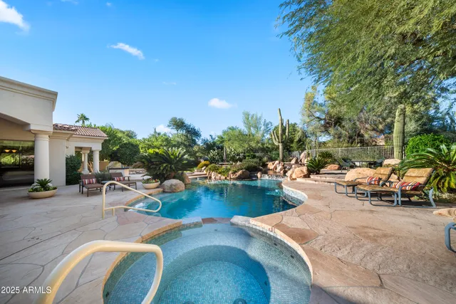 a view of swimming pool with outdoor seating and plants