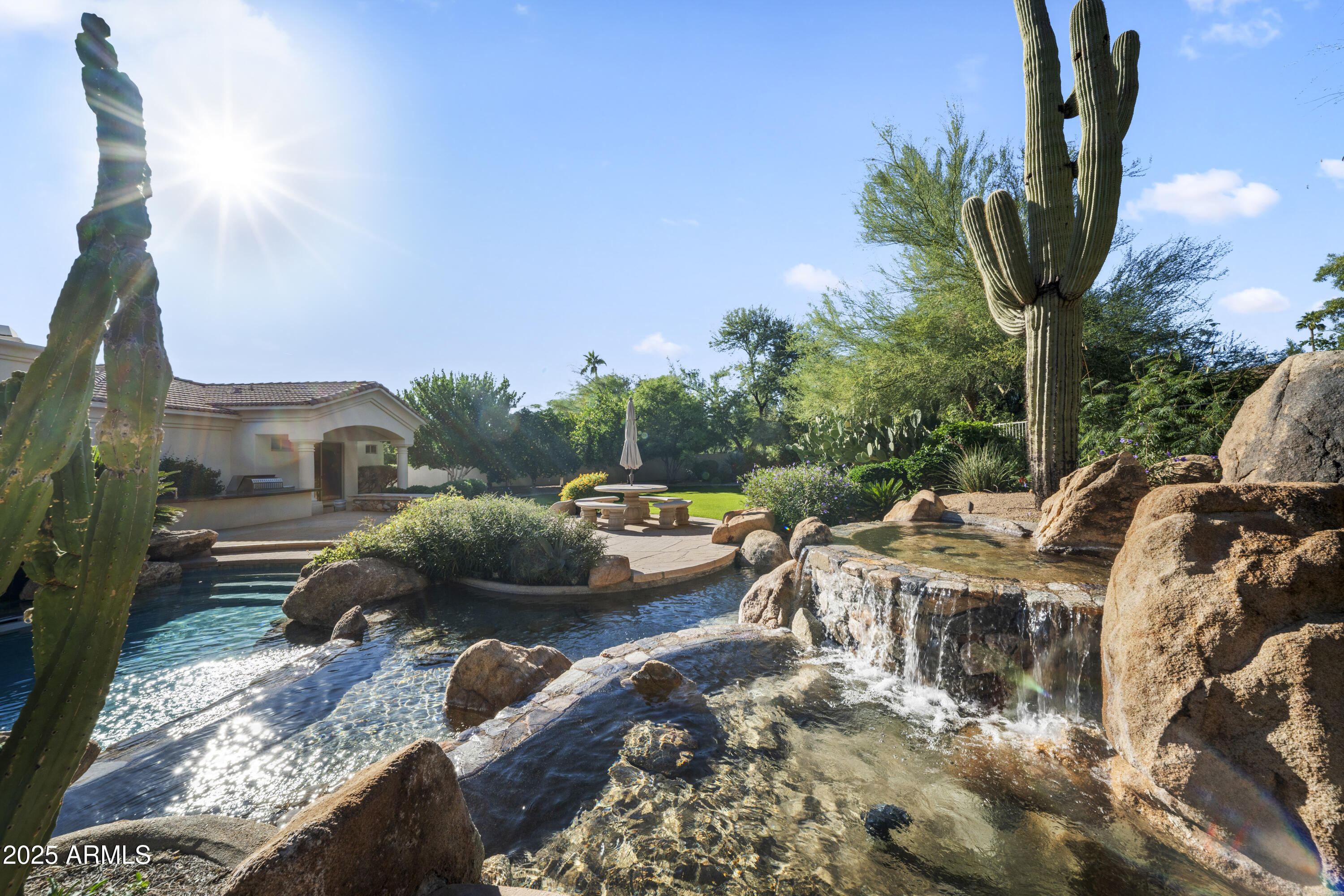 8350 East Via Del Sol Drive Scottsdale, AZ 85255 - Photo 10 of 42 a front view of a house with garden and trees