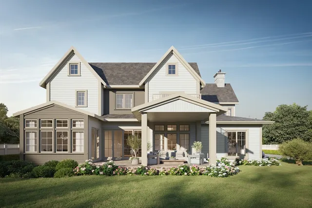 a front view of a house with a yard table and chairs