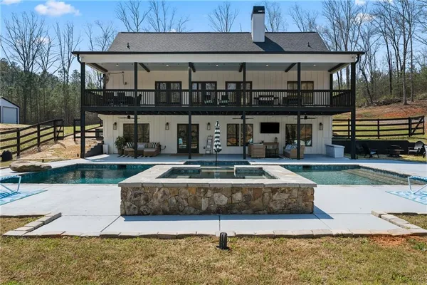 a front view of a house with a yard table and chairs