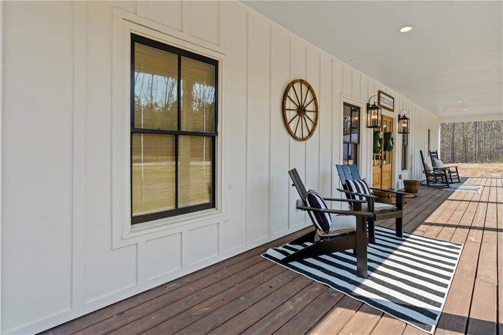 211 Cowart Road Dawsonville, GA 30534 - Photo 11 of 101 a view of a hallway with wooden floor and furniture