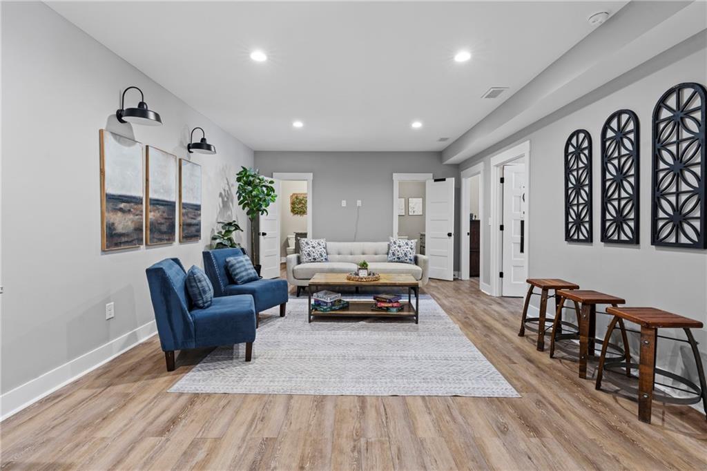 211 Cowart Road Dawsonville, GA 30534 - Photo 15 of 101 a living room with furniture and a wooden floor