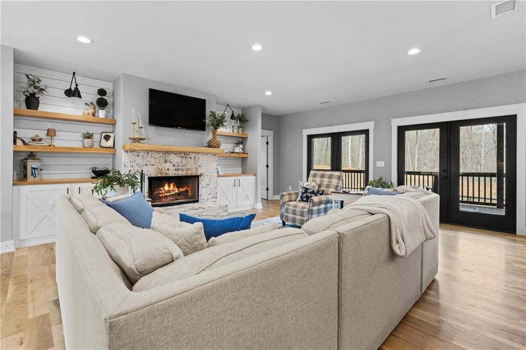 211 Cowart Road Dawsonville, GA 30534 - Photo 20 of 101 a living room with furniture fireplace and a flat screen tv