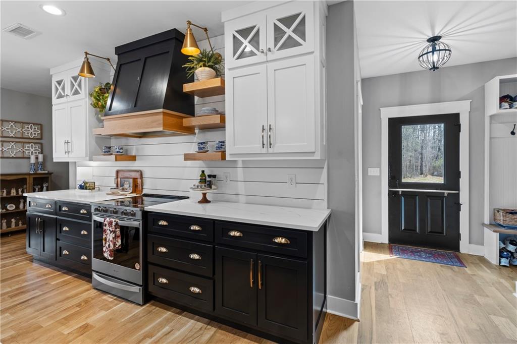 211 Cowart Road Dawsonville, GA 30534 - Photo 28 of 101 a kitchen with stainless steel appliances granite countertop a stove and cabinets