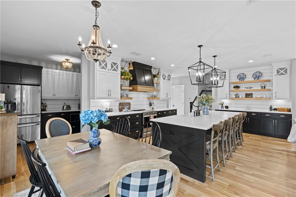 211 Cowart Road Dawsonville, GA 30534 - Photo 36 of 101 a view of a dining room with furniture a chandelier and wooden floor