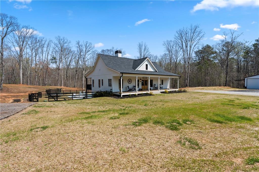 211 Cowart Road Dawsonville, GA 30534 - Photo 4 of 101 a front view of a house with a yard table and chairs