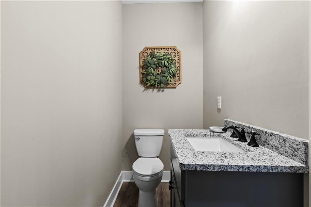 211 Cowart Road Dawsonville, GA 30534 - Photo 45 of 101 a bathroom with a granite countertop sink and a toilet