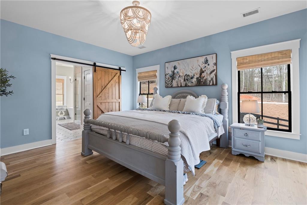 211 Cowart Road Dawsonville, GA 30534 - Photo 52 of 101 a spacious bedroom with a bed and a window