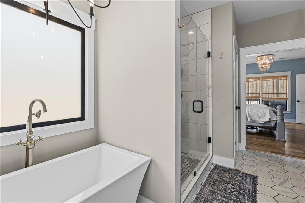 211 Cowart Road Dawsonville, GA 30534 - Photo 58 of 101 a bathroom with a bathtub and a shower