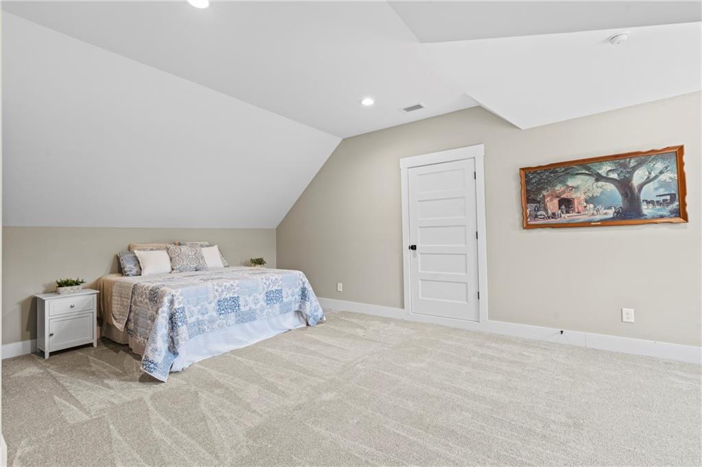 211 Cowart Road Dawsonville, GA 30534 - Photo 75 of 101 a spacious bedroom with a bed and painting on the wall