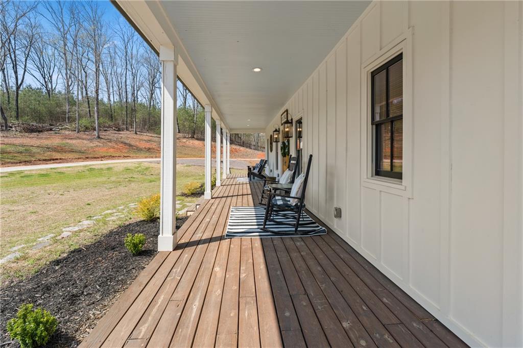 211 Cowart Road Dawsonville, GA 30534 - Photo 8 of 101 a view of balcony with wooden floor and outdoor seating