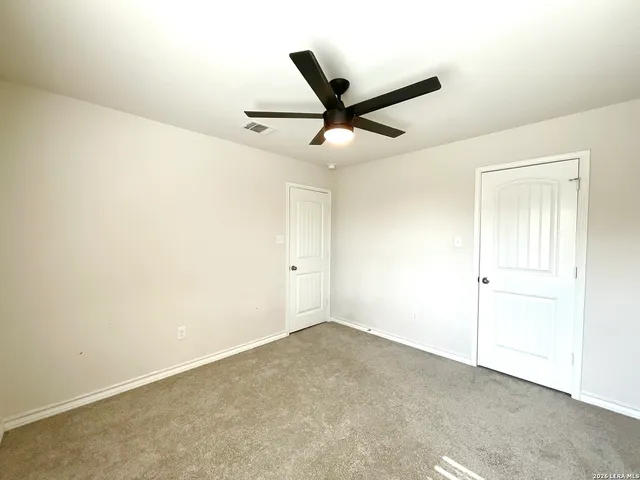 a kitchen with stainless steel appliances a stove top oven a sink a refrigerator white cabinets and wooden floor