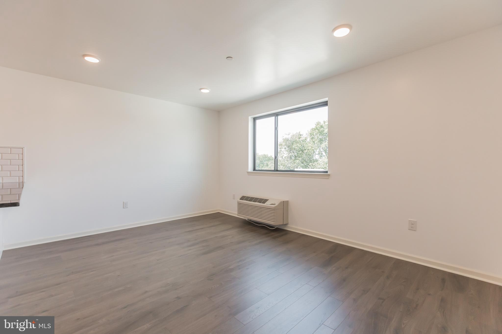 6778 Ridge Avenue, Unit 406 Philadelphia, PA 19128 - Photo 8 of 11 an empty room with wooden floor and windows