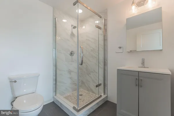 a bathroom with a shower a toilet and sink