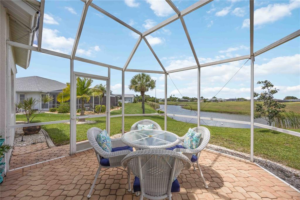 48 Bunker Road Rotonda West, FL 33947 - Photo 36 of 59 a view of a chair and tables in the patio