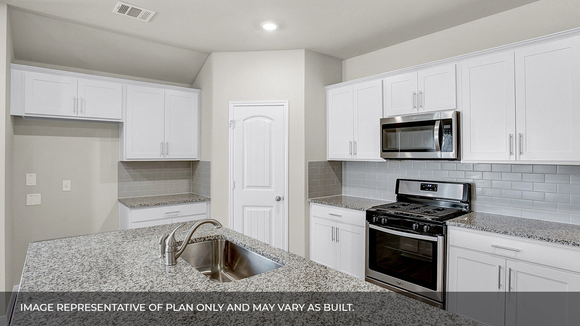167 Mountain Pea Road Kyle, TX 78640 - Photo 7 of 21 a kitchen with granite countertop a sink and a stove top oven with white cabinets