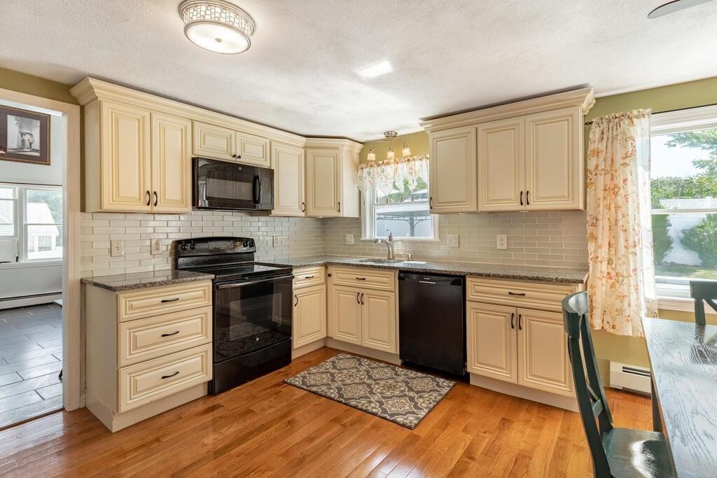 10 John Road Peabody, MA 01960 - Photo 13 of 35 a kitchen with granite countertop a sink cabinets stainless steel appliances and a window
