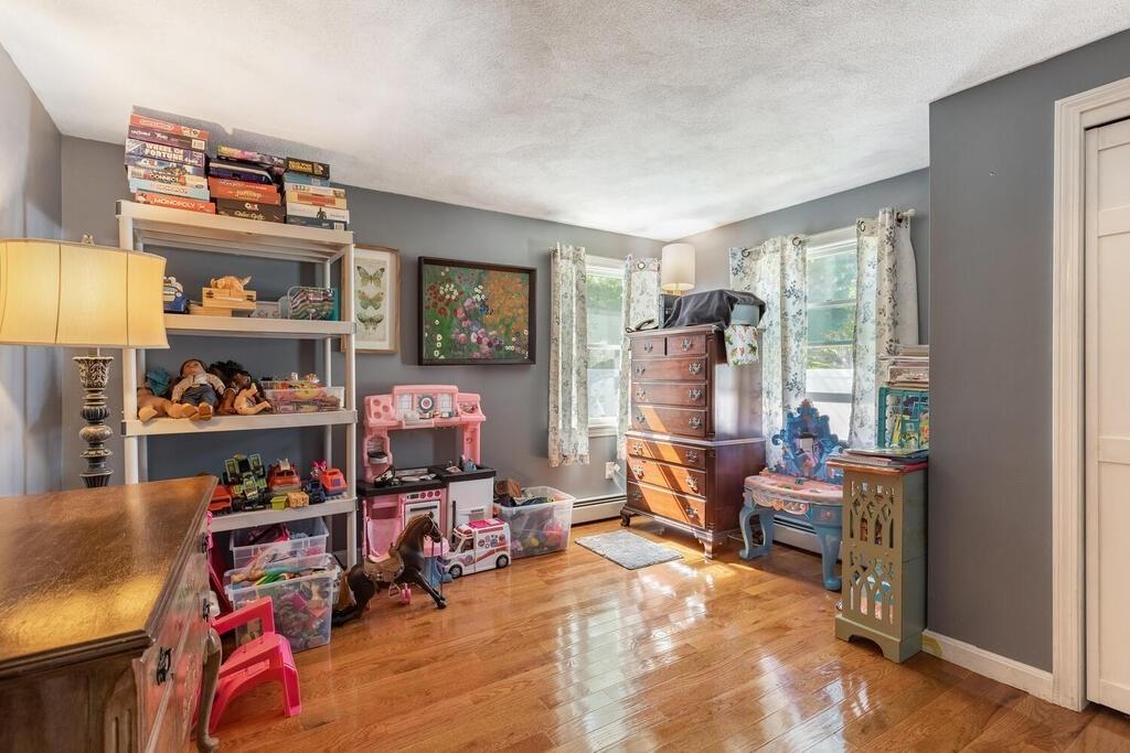 10 John Road Peabody, MA 01960 - Photo 21 of 35 a room with lots of furniture and a wooden floor