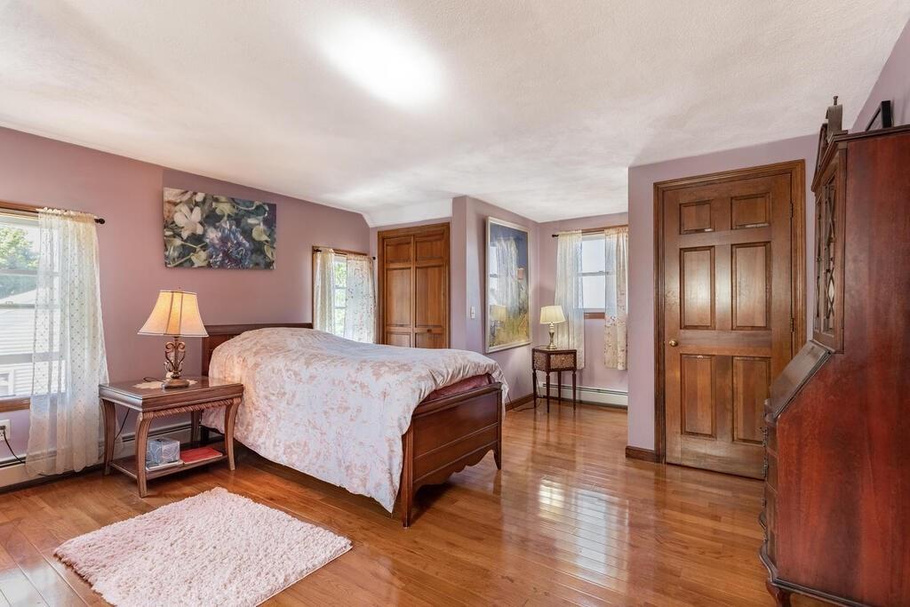 10 John Road Peabody, MA 01960 - Photo 26 of 35 a bedroom with a bed wooden floor and a lamp on desk