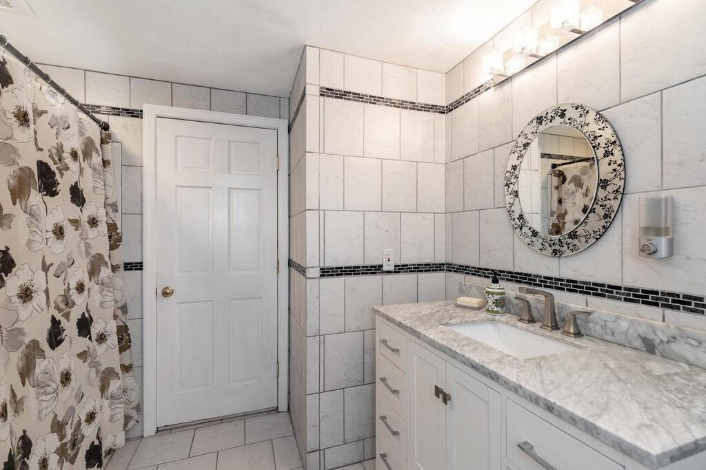 10 John Road Peabody, MA 01960 - Photo 28 of 35 a bathroom with a granite countertop sink mirror and shower