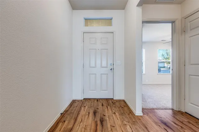 wooden floor in a hall with an empty room