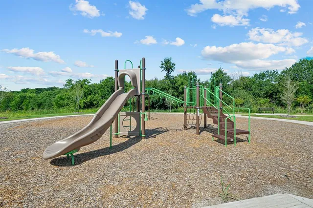 a view of outdoor space with playground and green space