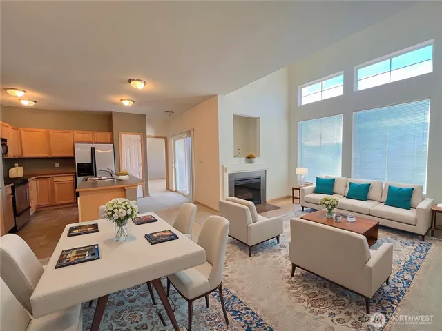 a living room with furniture fireplace and a table