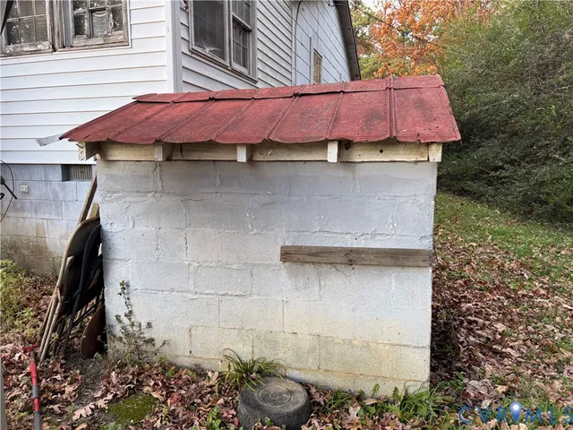 a view of a house with a patio and a yard