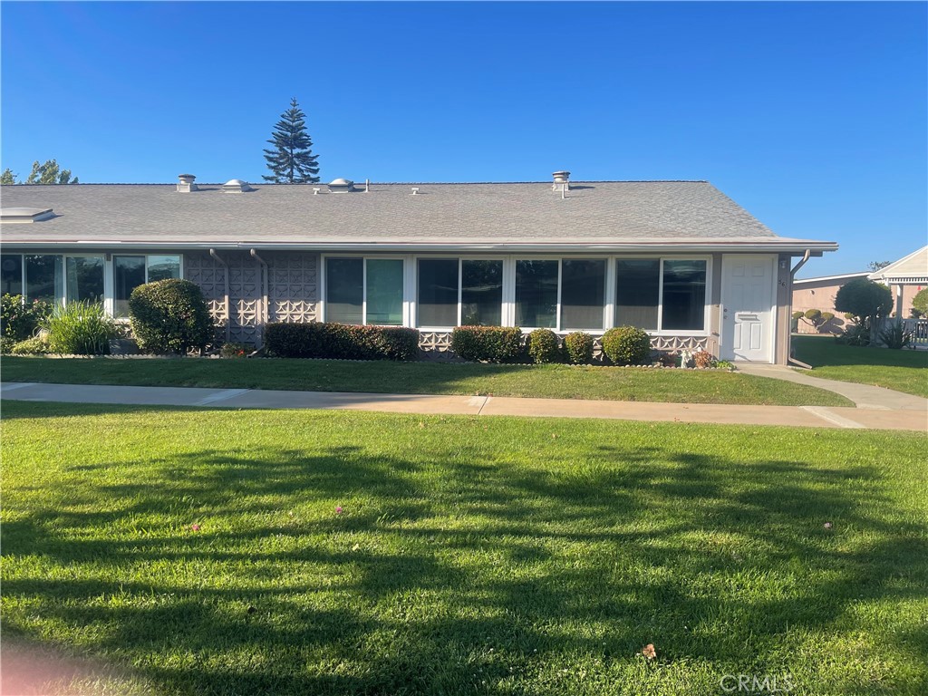 1281 Mayfield Road, Unit 6 56A Seal Beach, CA 90740 - Photo 2 of 10 a front view of a house with a garden