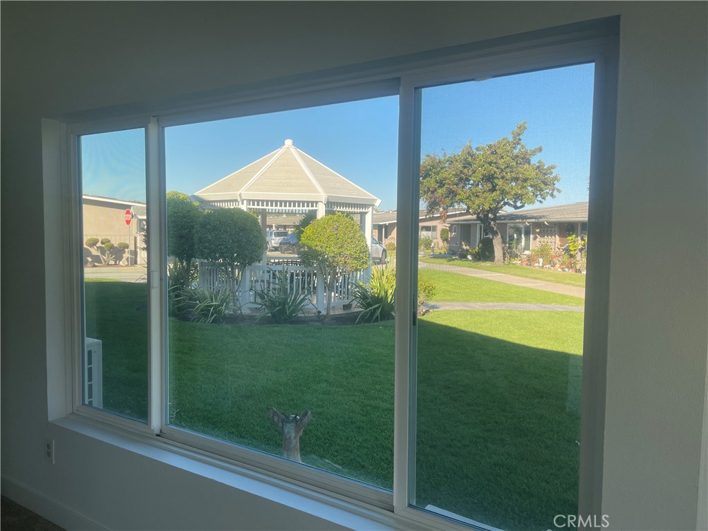 1281 Mayfield Road, Unit 6 56A Seal Beach, CA 90740 - Photo 4 of 10 a view of a glass door and a yard
