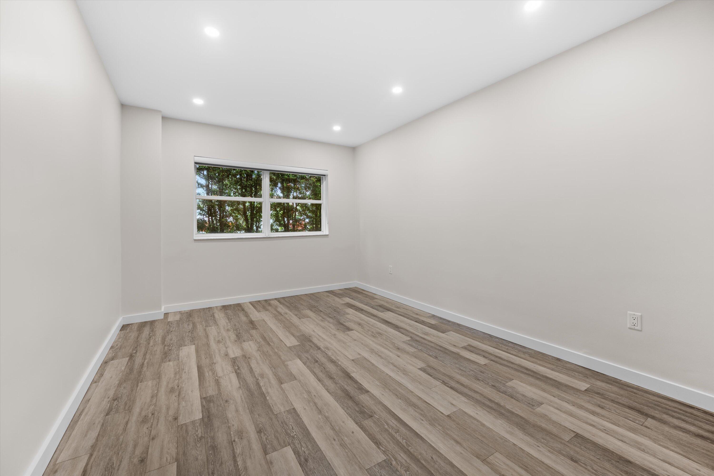 44 Cocoanut Row, Unit T27 Palm Beach, FL 33480 - Photo 16 of 40 a view of an empty room with wooden floor and a window