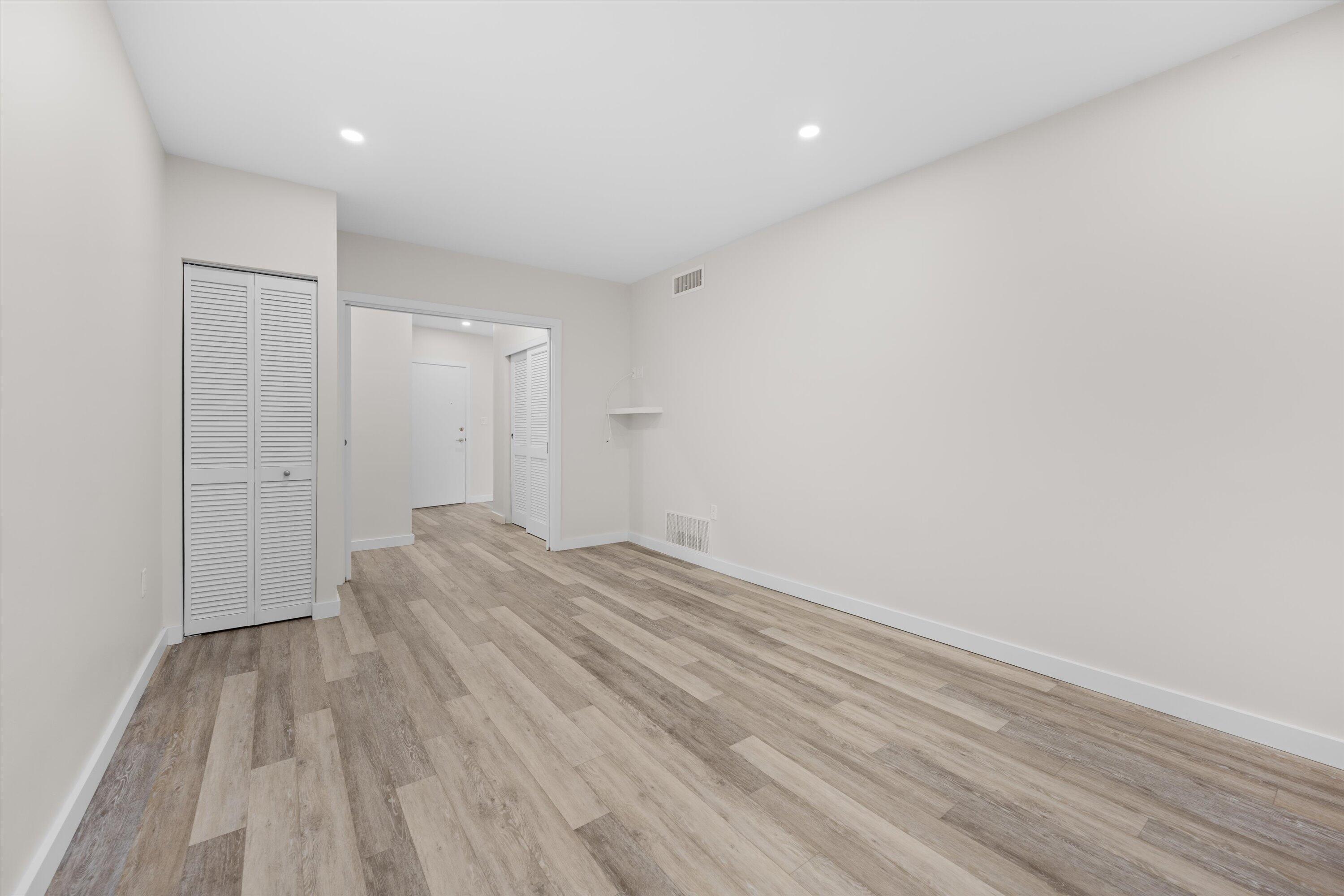 44 Cocoanut Row, Unit T27 Palm Beach, FL 33480 - Photo 17 of 40 a view of a room with wooden floor and white walls