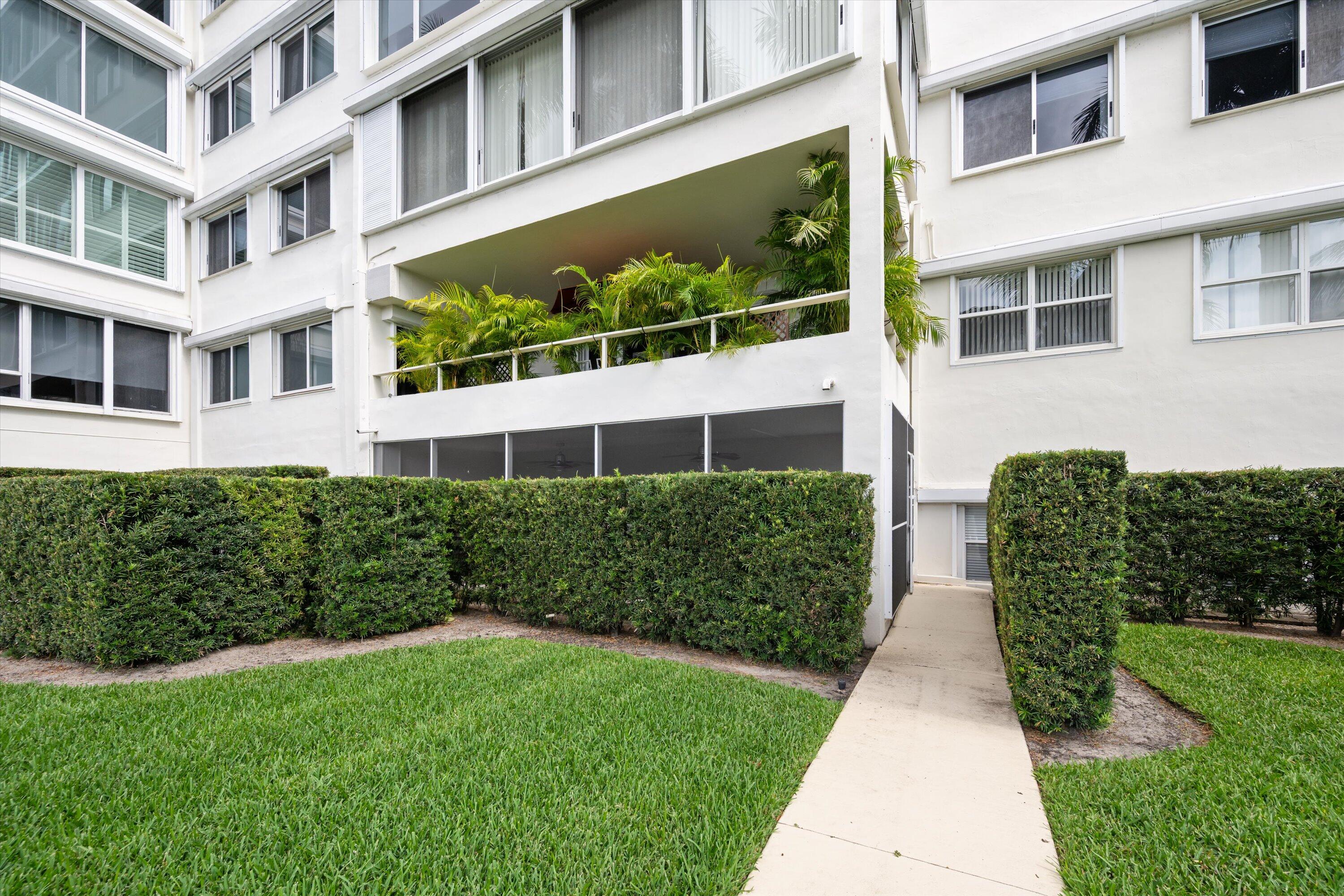 44 Cocoanut Row, Unit T27 Palm Beach, FL 33480 - Photo 29 of 40 a front view of a building with a garden