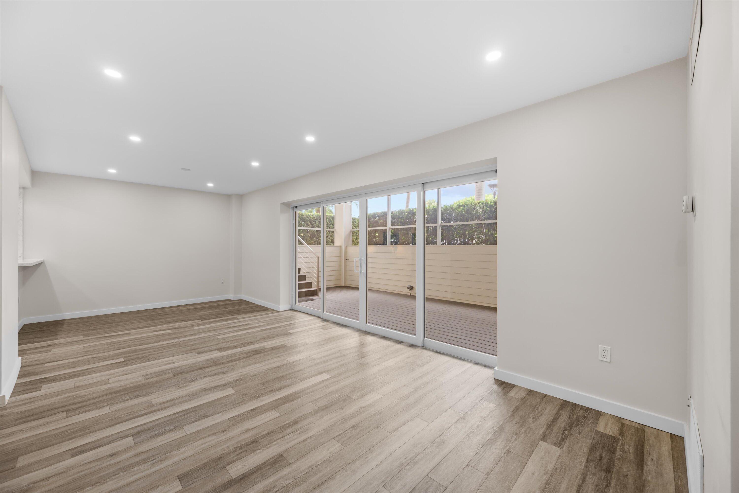 44 Cocoanut Row, Unit T27 Palm Beach, FL 33480 - Photo 3 of 40 an empty room with wooden floor and windows
