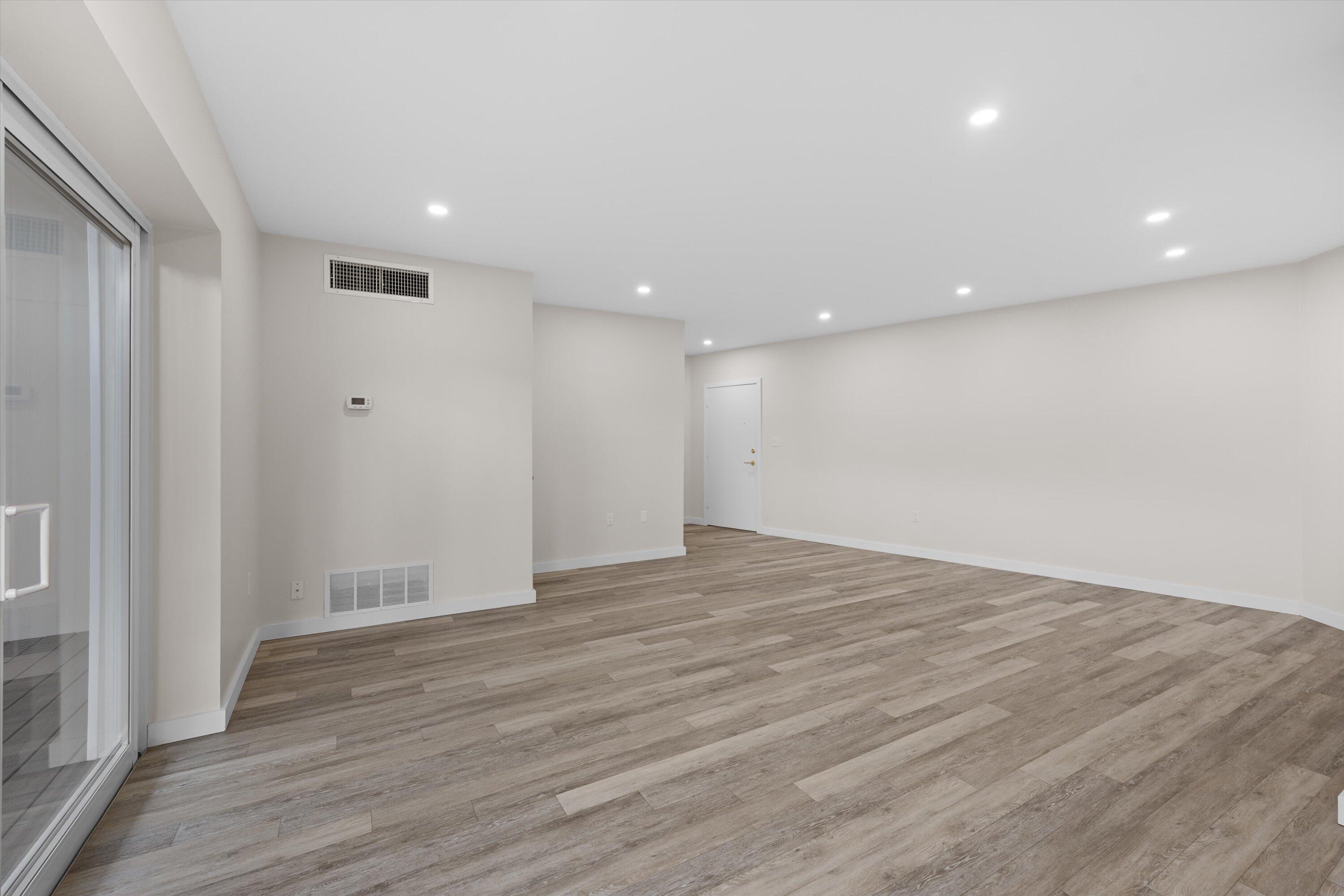 44 Cocoanut Row, Unit T27 Palm Beach, FL 33480 - Photo 4 of 40 a view of an empty room with wooden floor and a window