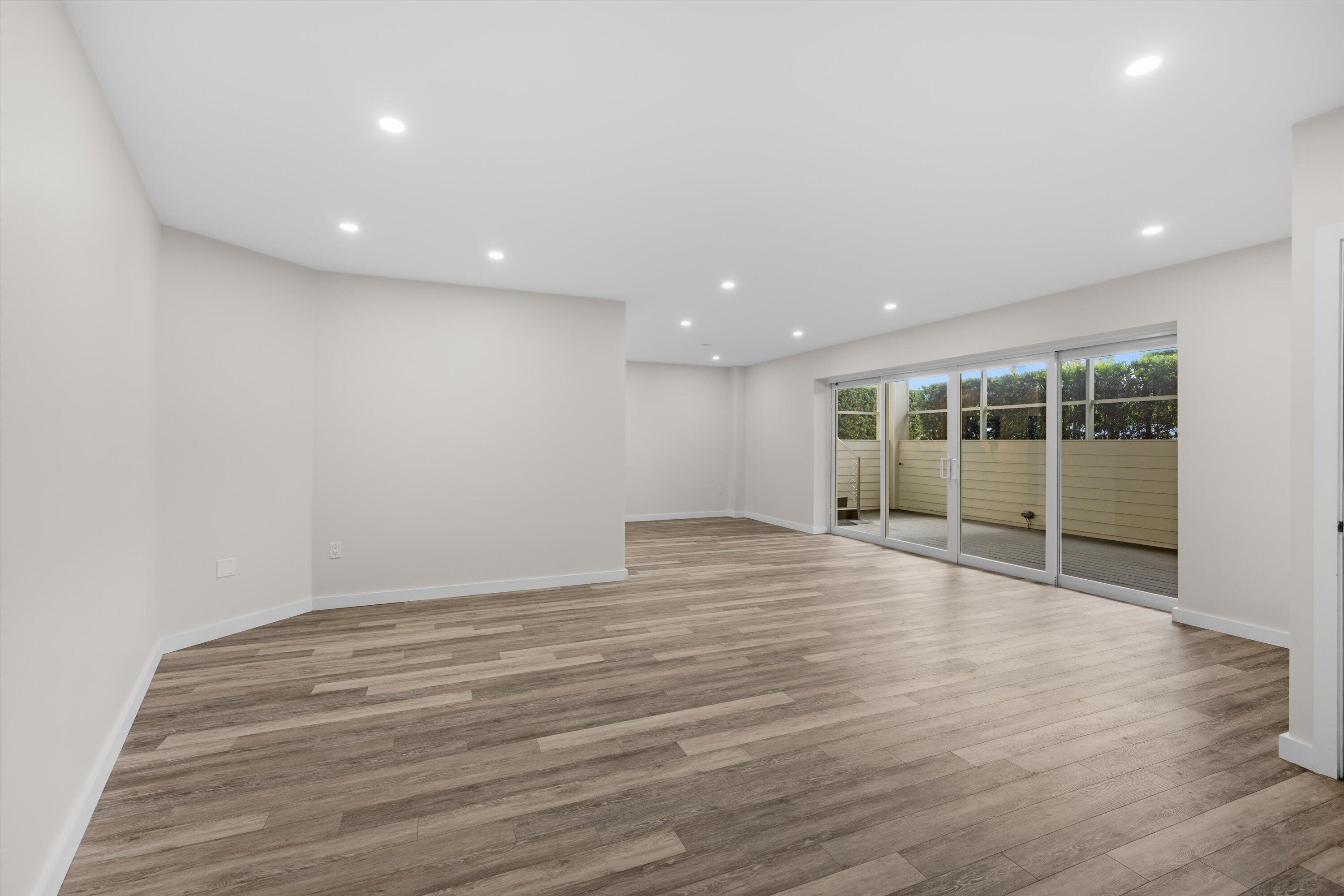 44 Cocoanut Row, Unit T27 Palm Beach, FL 33480 - Photo 5 of 40 a view of an empty room with wooden floor and a window