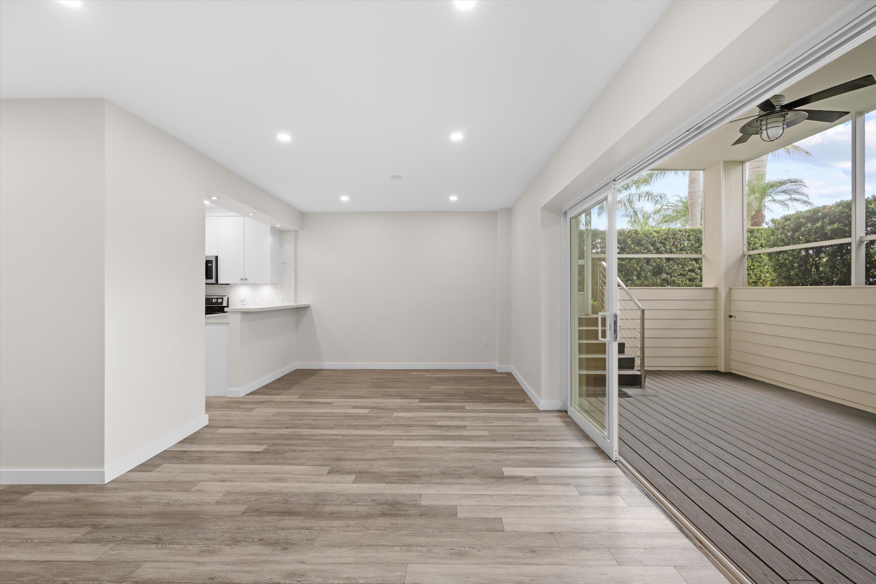 44 Cocoanut Row, Unit T27 Palm Beach, FL 33480 - Photo 6 of 40 a view of an empty room with wooden floor and a window