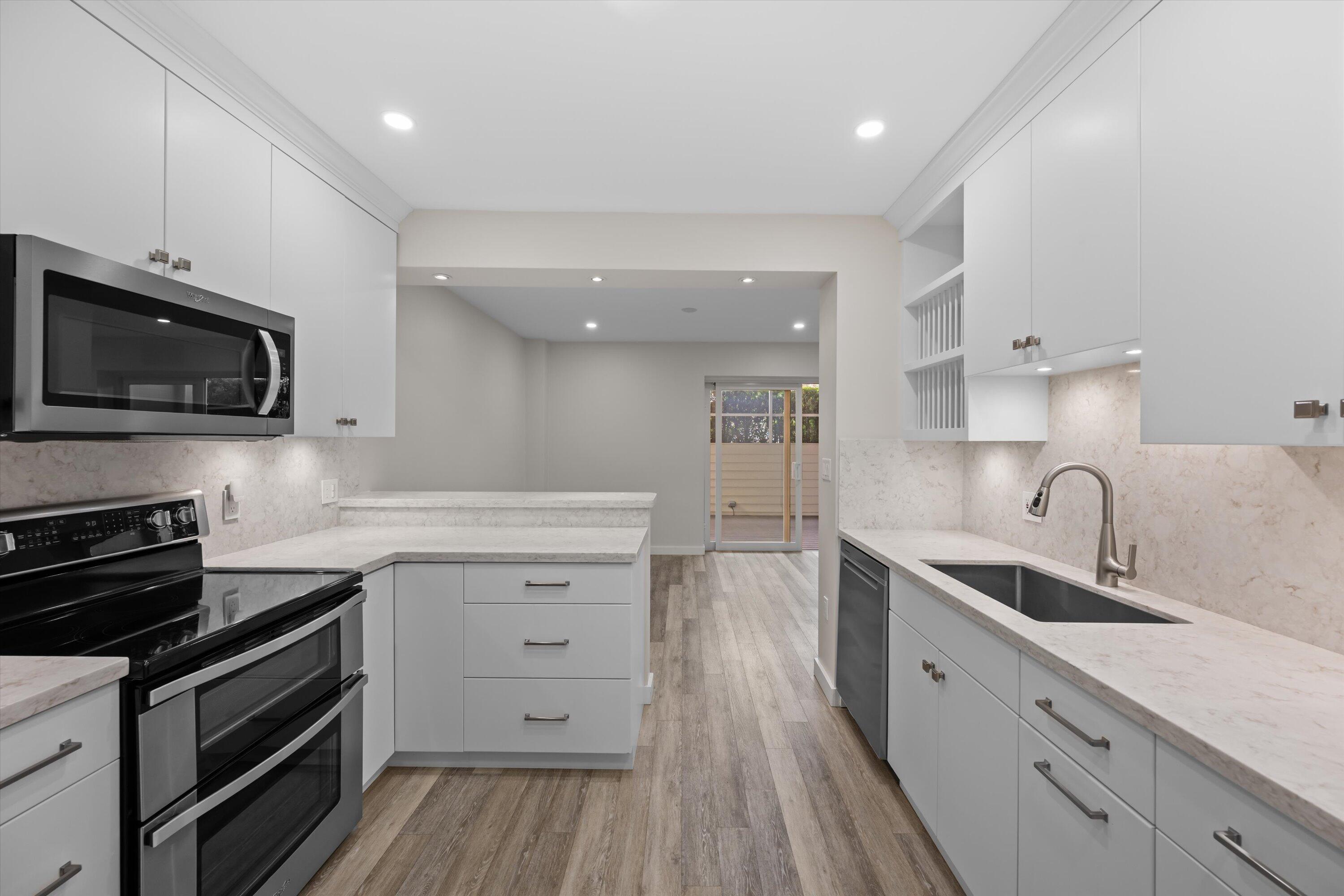 44 Cocoanut Row, Unit T27 Palm Beach, FL 33480 - Photo 8 of 40 a kitchen with a sink stove and microwave