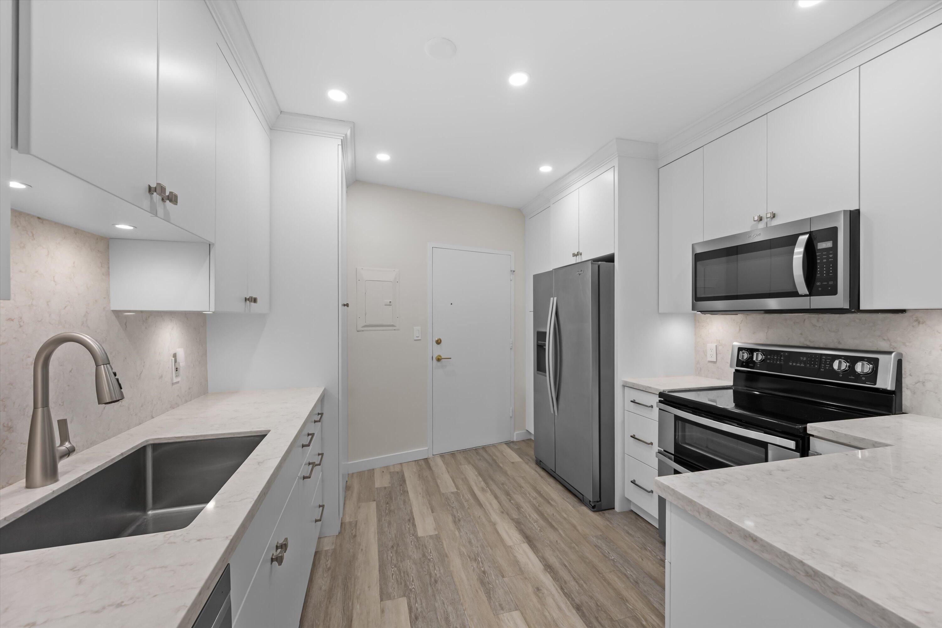 44 Cocoanut Row, Unit T27 Palm Beach, FL 33480 - Photo 9 of 40 a kitchen with a sink appliances and cabinets