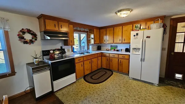 a kitchen with stainless steel appliances granite countertop a refrigerator stove and sink